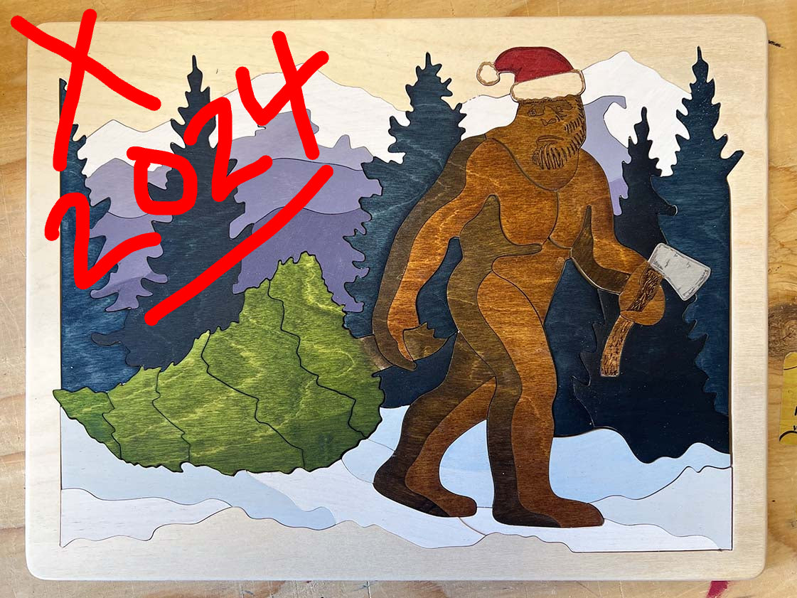 A puzzle depicting a sasquatch with a Santa hat in a wintry landscape with snow-covered trees and mountains in the background. No longer available.