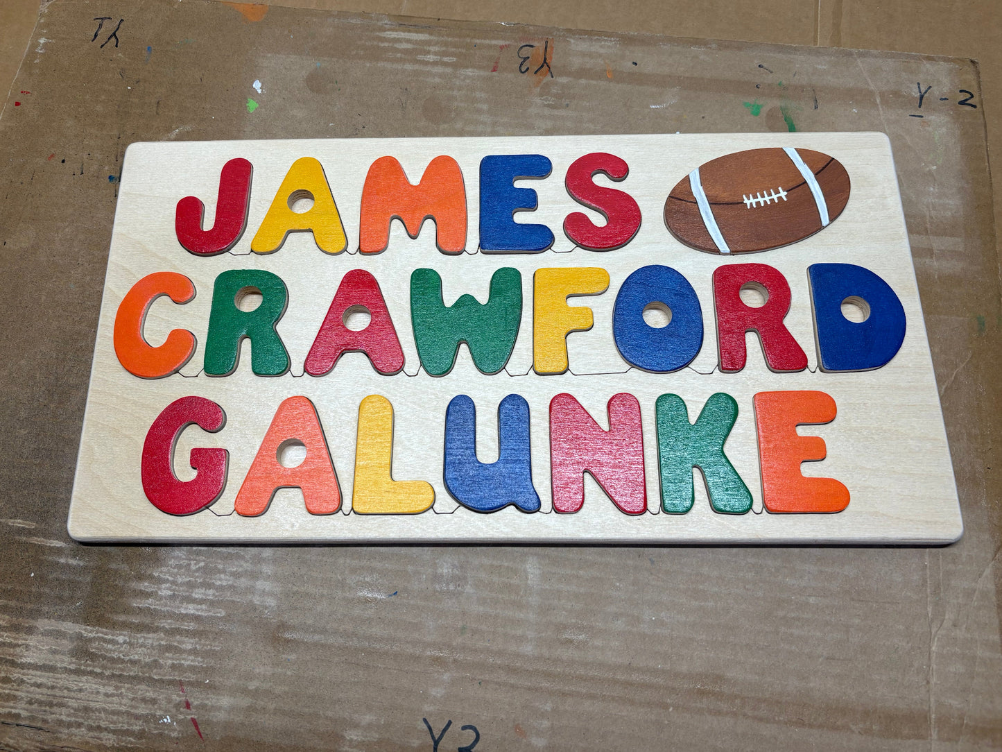 Colorful wooden puzzle with letters on a cardboard background