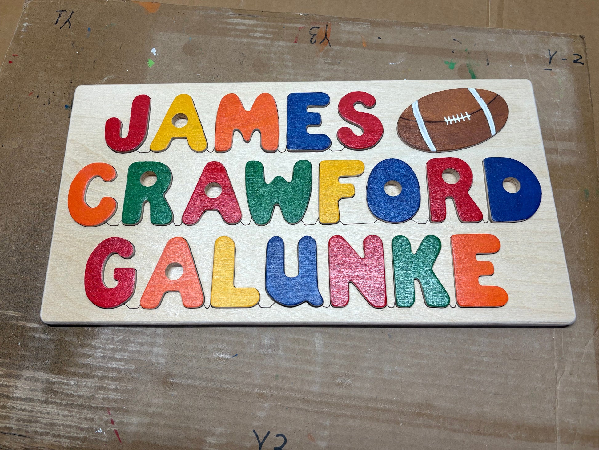 Colorful wooden puzzle with letters on a cardboard background