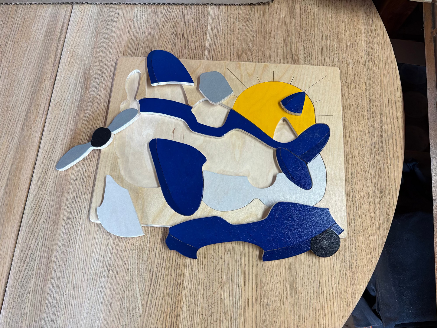 Airplane puzzle pieces on a wooden surface