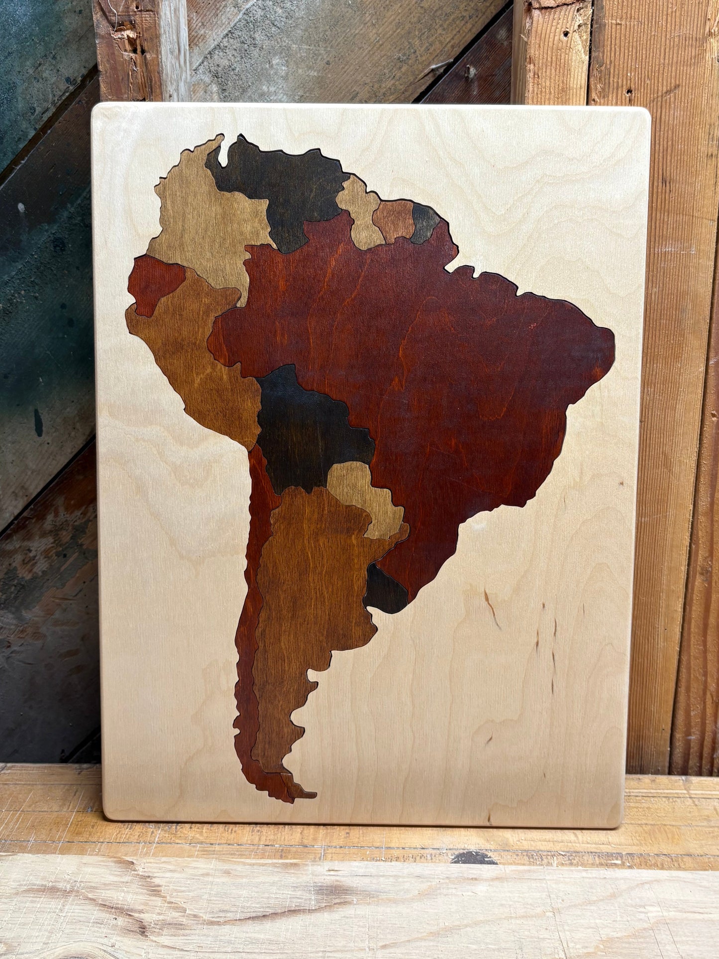 Wooden puzzle of South America colored in wood tones.