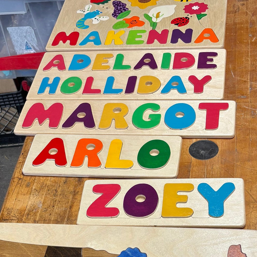 Wooden puzzle with colorful letters and a map of America.