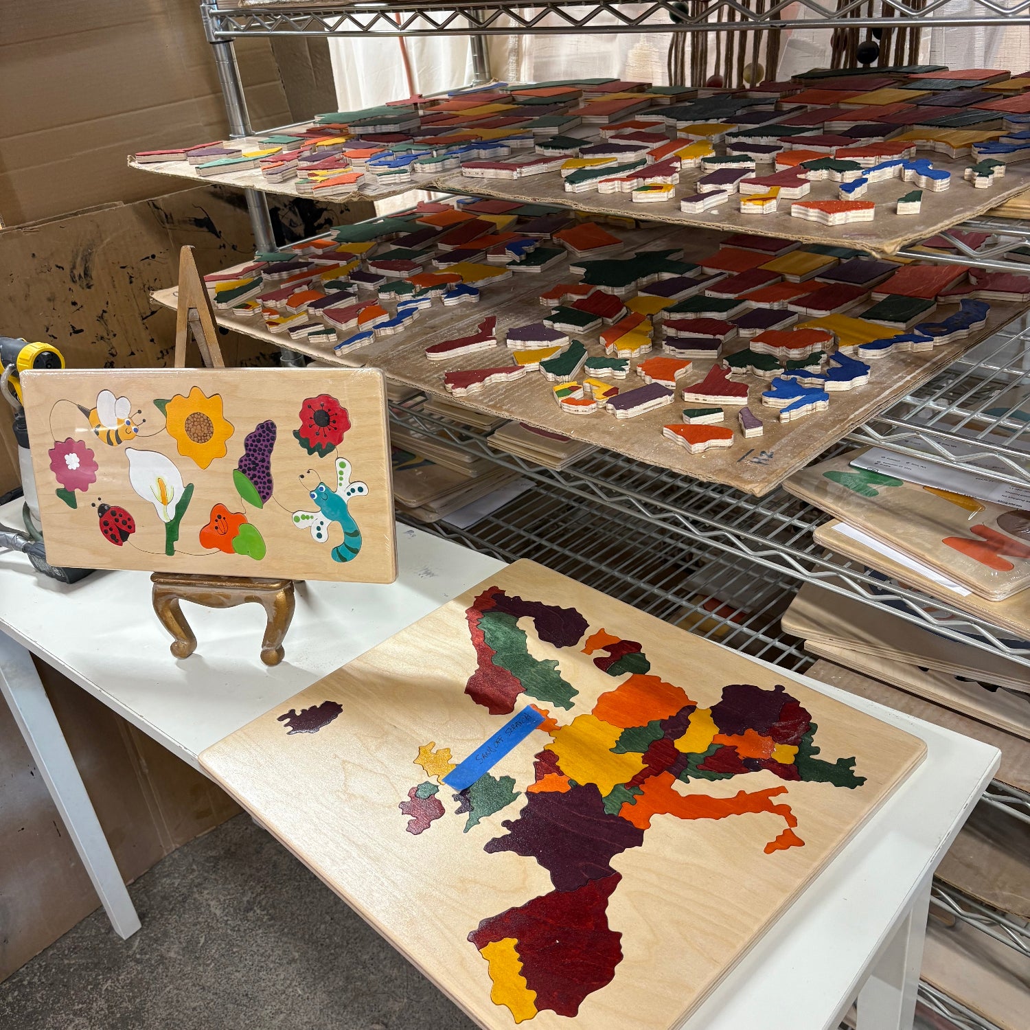 Wooden puzzle with colorful animals and flowers on a stand