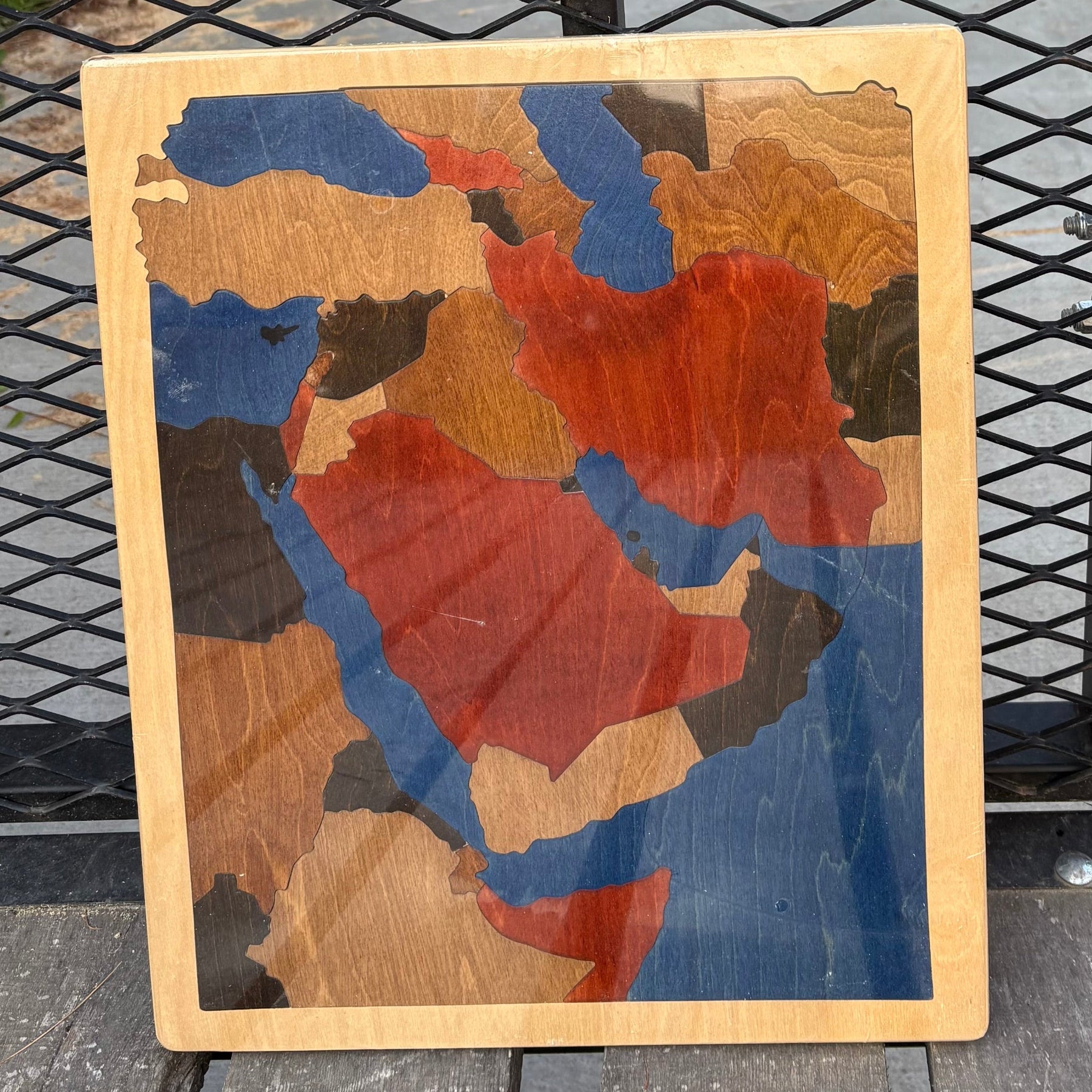 Wooden puzzle map of the Middle East colored in wood tones.