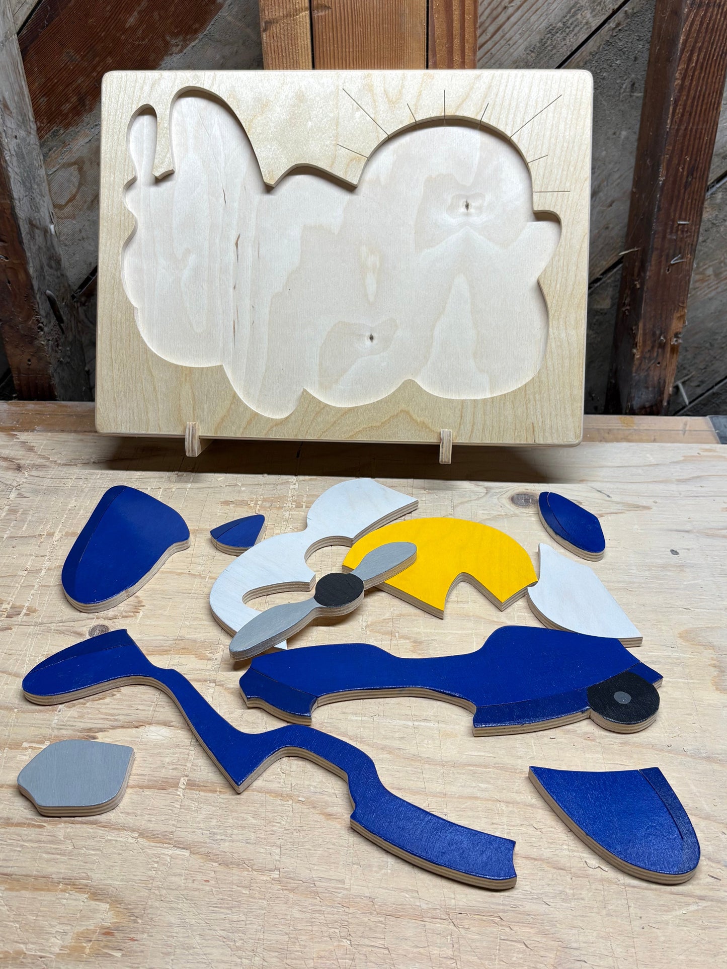 Wooden pieces of airplane puzzle  shapes on a wooden surface